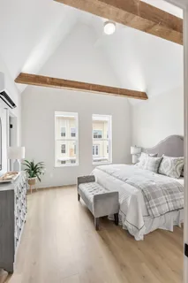 a bedroom with a bed and a window