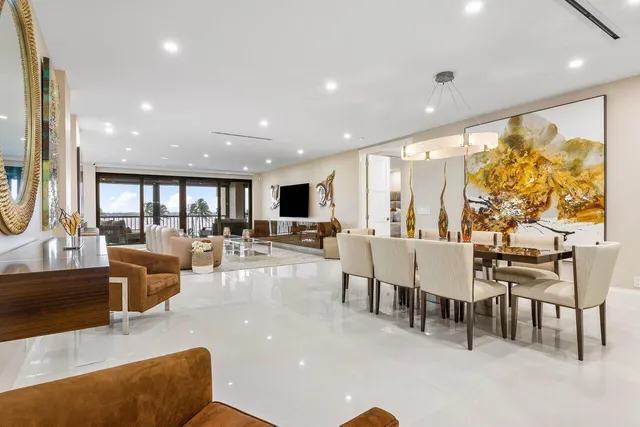 a view of a hallway with a couch and a view of living room