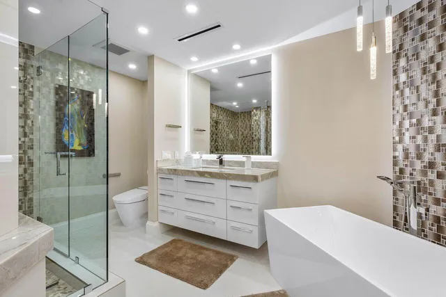 a bathroom with a tub a sink and mirrors