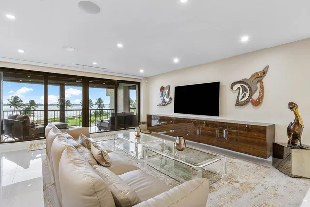 a living room with furniture tv and a large window