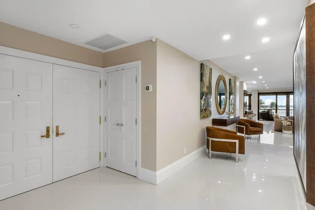 an aerial view of residential houses with outdoor space and ocean view