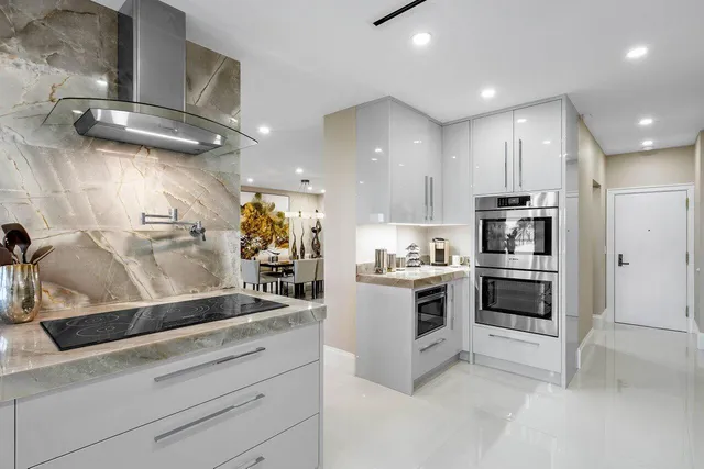 a kitchen with stainless steel appliances kitchen island granite countertop a sink and cabinets