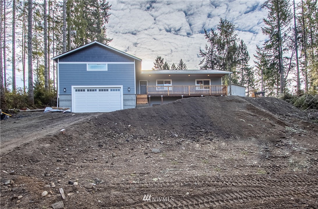 5031 East Rasor Road Belfair, WA 98528 - Photo 1 of 16 a view of a house with a yard