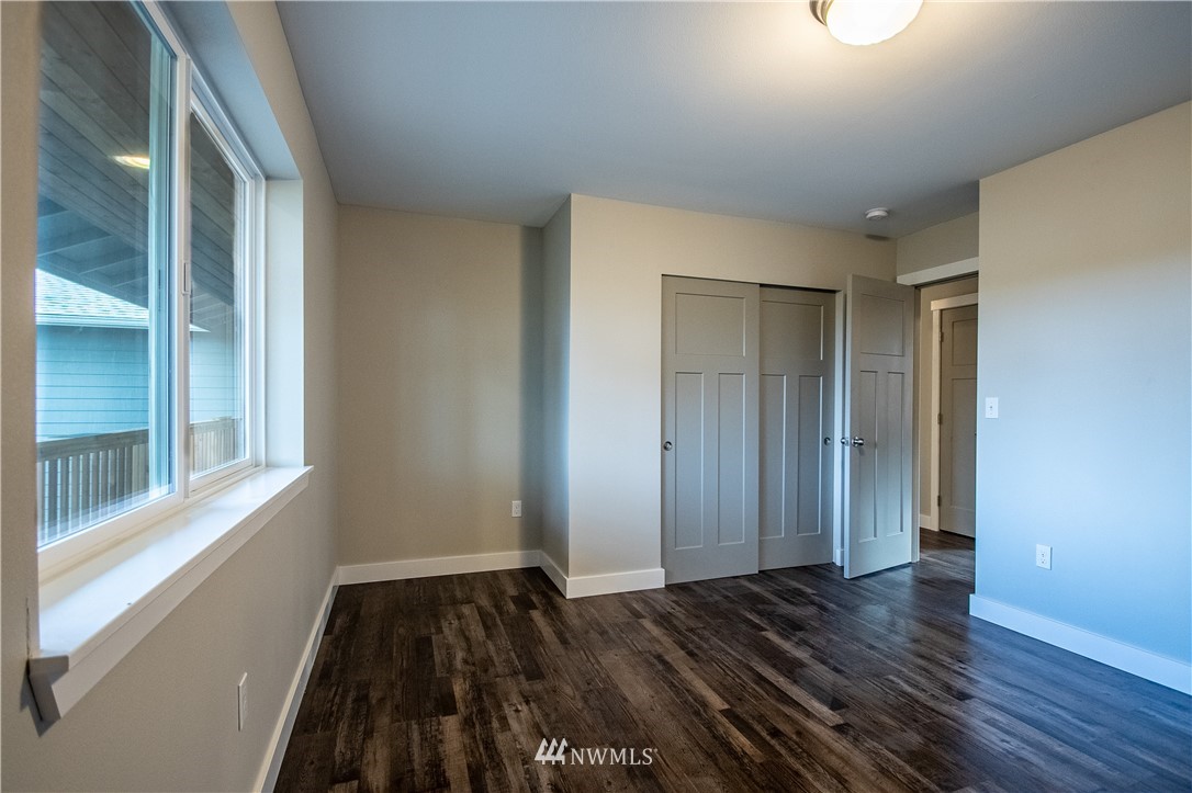 5031 East Rasor Road Belfair, WA 98528 - Photo 11 of 16 a view of a room with wooden floor and a window