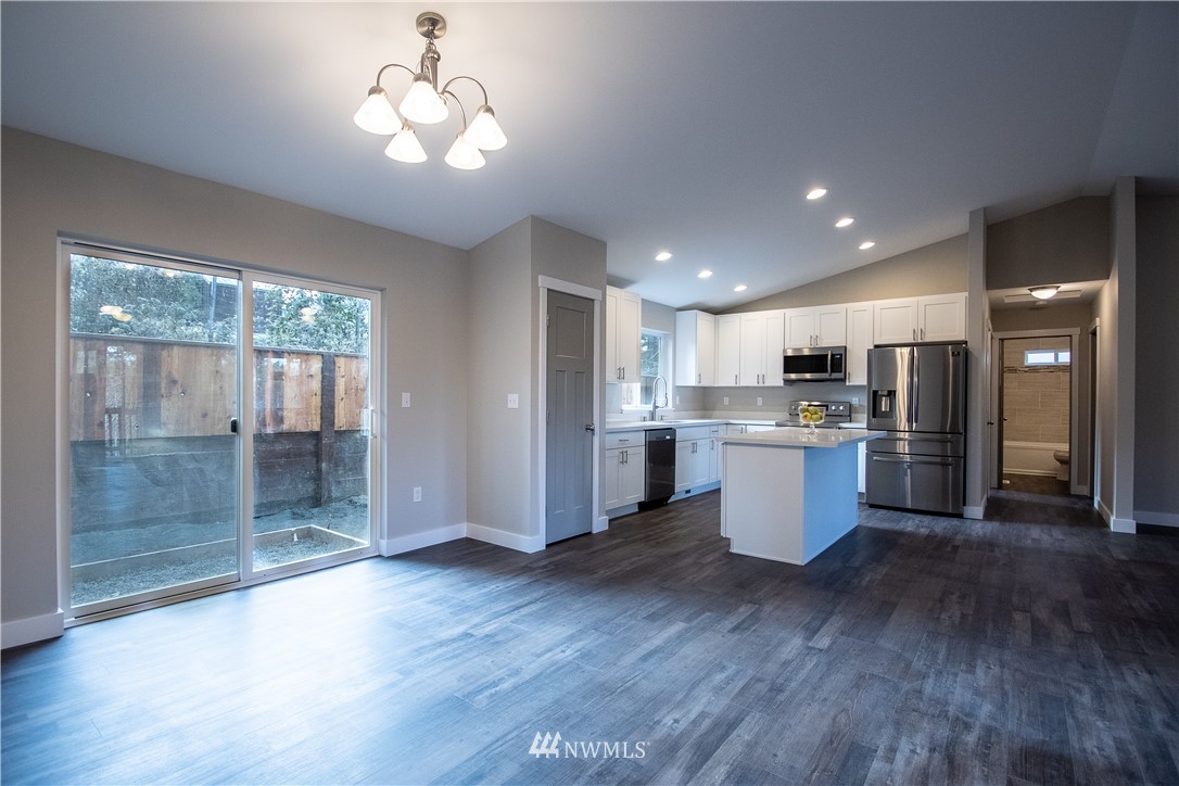 5031 East Rasor Road Belfair, WA 98528 - Photo 5 of 16 a large kitchen with cabinets and wooden floor