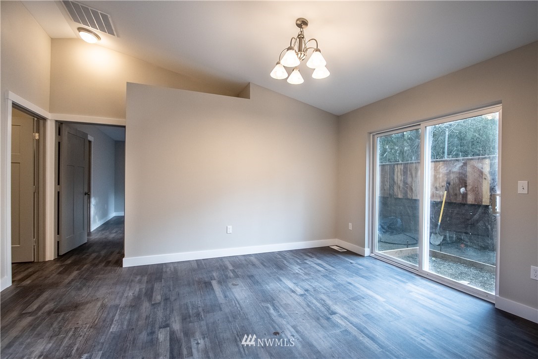 5031 East Rasor Road Belfair, WA 98528 - Photo 6 of 16 wooden floor in an empty room with a window