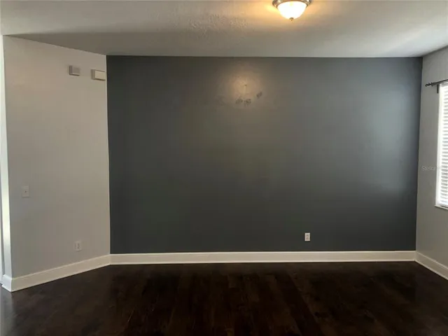a view of an empty room and wooden floor