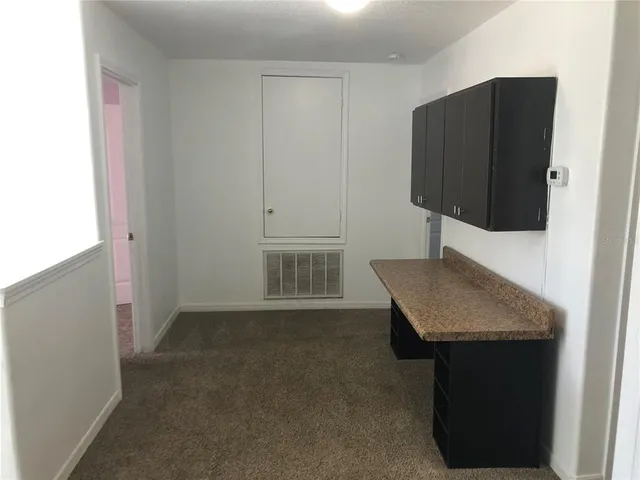 a kitchen with a sink and a refrigerator