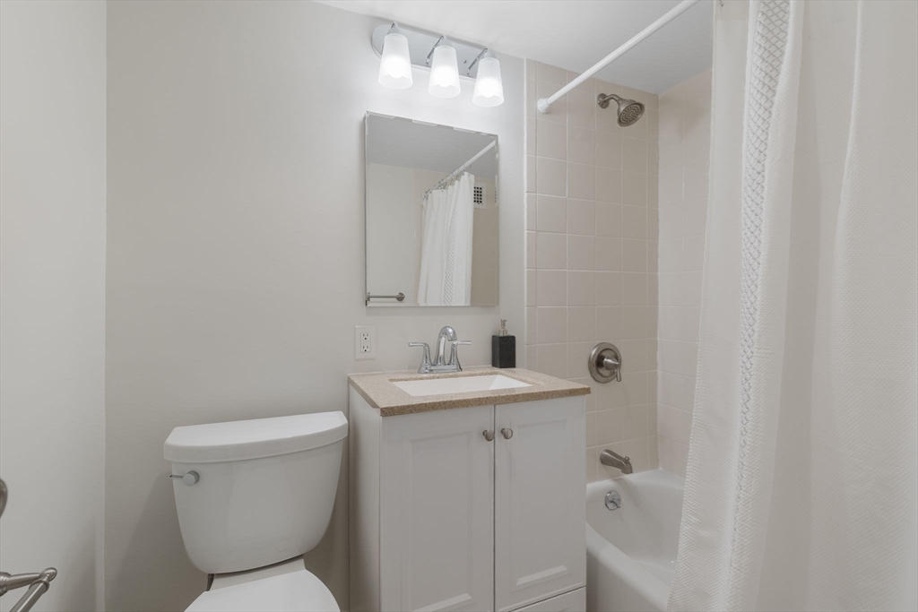 6 Whittier Place, Unit 9H Boston, MA 02114 - Photo 16 of 26 a bathroom with a sink toilet and shower