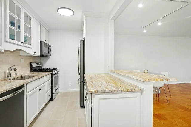 a kitchen with a sink and a stove top oven