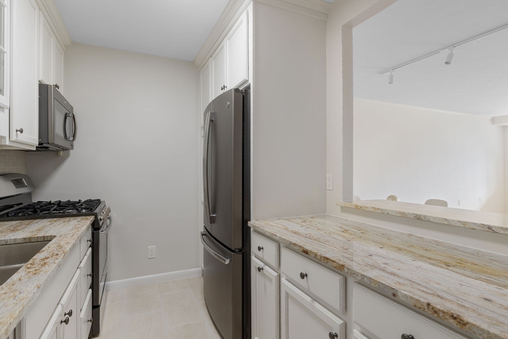 6 Whittier Place, Unit 9H Boston, MA 02114 - Photo 8 of 26 a kitchen with a sink and a stove top oven
