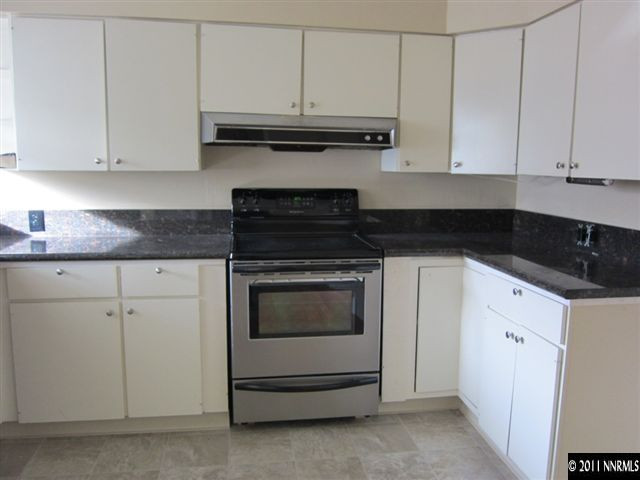 875 Lodge Avenue Reno, NV 89503 - Photo 2 of 13 a kitchen with granite countertop white cabinets and black appliances