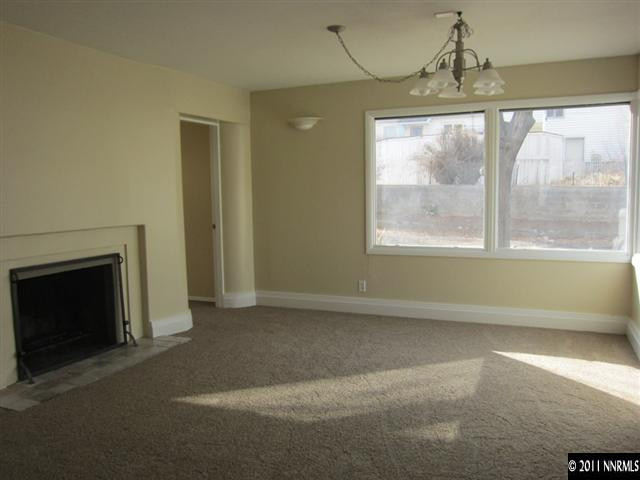 875 Lodge Avenue Reno, NV 89503 - Photo 3 of 13 a view of empty room with wooden floor and fireplace