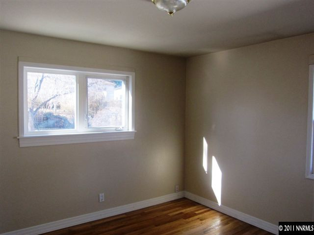 875 Lodge Avenue Reno, NV 89503 - Photo 8 of 13 a view of an empty room with wooden floor and a window