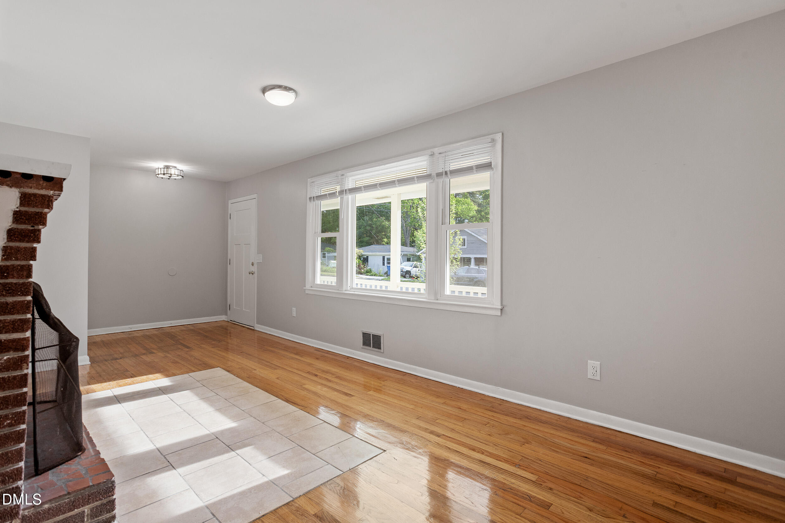 2414 Chapin Street Durham, NC 27707 - Photo 6 of 30 a view of an empty room with wooden floor and a window