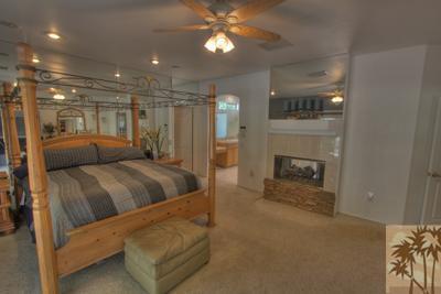 43094 Joshua Road Rancho Mirage, CA 92270 - Photo 15 of 25 a room with a bed and a fireplace
