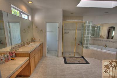 43094 Joshua Road Rancho Mirage, CA 92270 - Photo 16 of 25 a bathroom with a tub sink double vanity and tub