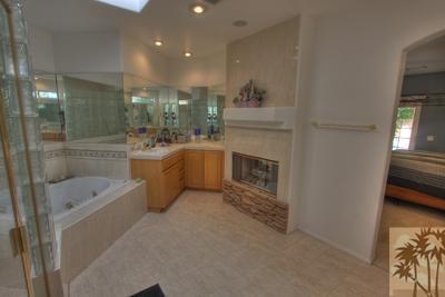43094 Joshua Road Rancho Mirage, CA 92270 - Photo 17 of 25 a bathroom with a tub a sink and mirror