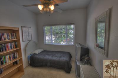 43094 Joshua Road Rancho Mirage, CA 92270 - Photo 18 of 25 a living room with a bed and a book shelf