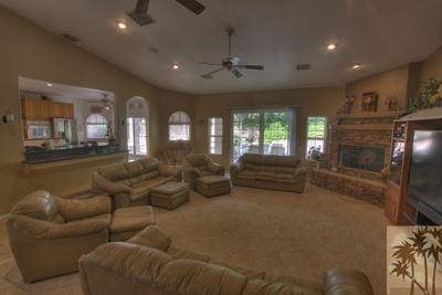 43094 Joshua Road Rancho Mirage, CA 92270 - Photo 6 of 25 a living room with furniture and a flat screen tv