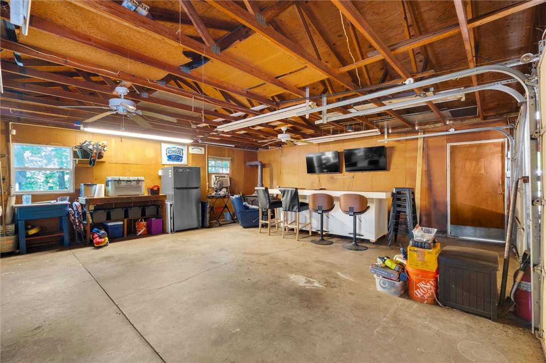 1815 Pearman Dairy Road Anderson, SC 29625 - Photo 27 of 35 A versatile garage space offers ample storage, an exposed beam ceiling, and a casual entertainment area.