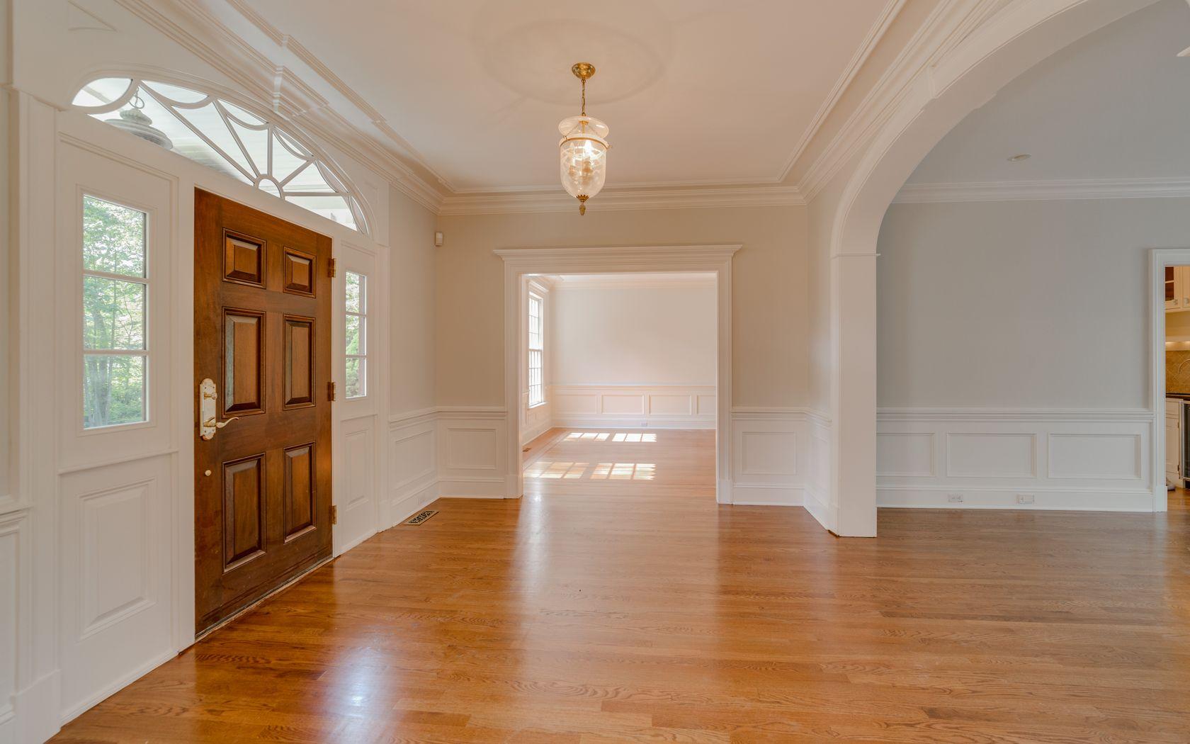1601 Ponus Ridge Road New Canaan, CT 06840 - Photo 24 of 88 a view of an empty room with wooden floor and a window