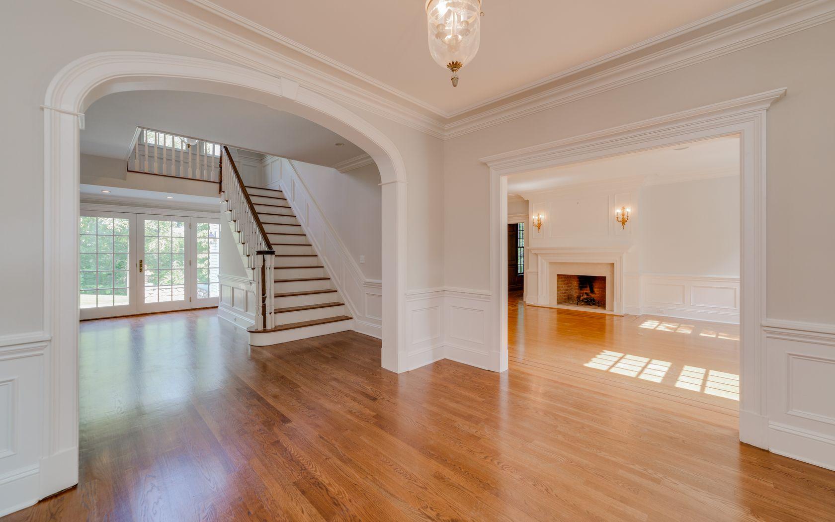 1601 Ponus Ridge Road New Canaan, CT 06840 - Photo 27 of 88 a view of a hallway with wooden floor windows and a chandelier