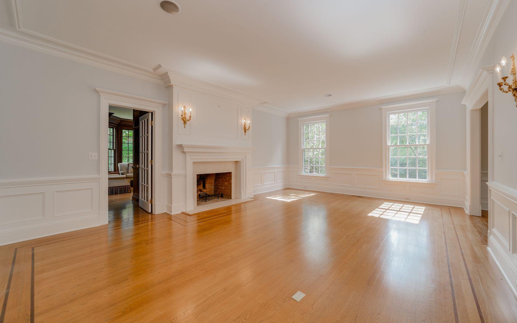 1601 Ponus Ridge Road New Canaan, CT 06840 - Photo 30 of 88 an empty room with wooden floor fireplace and windows