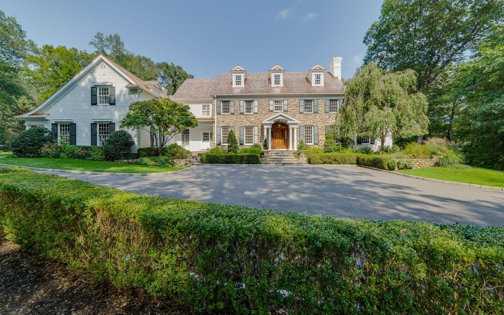 1601 Ponus Ridge Road New Canaan, CT 06840 - Photo 63 of 88 a front view of a house with a yard and garage