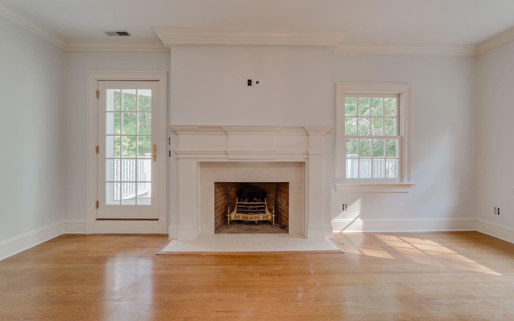 1601 Ponus Ridge Road New Canaan, CT 06840 - Photo 72 of 88 a living room with a fireplace and a window