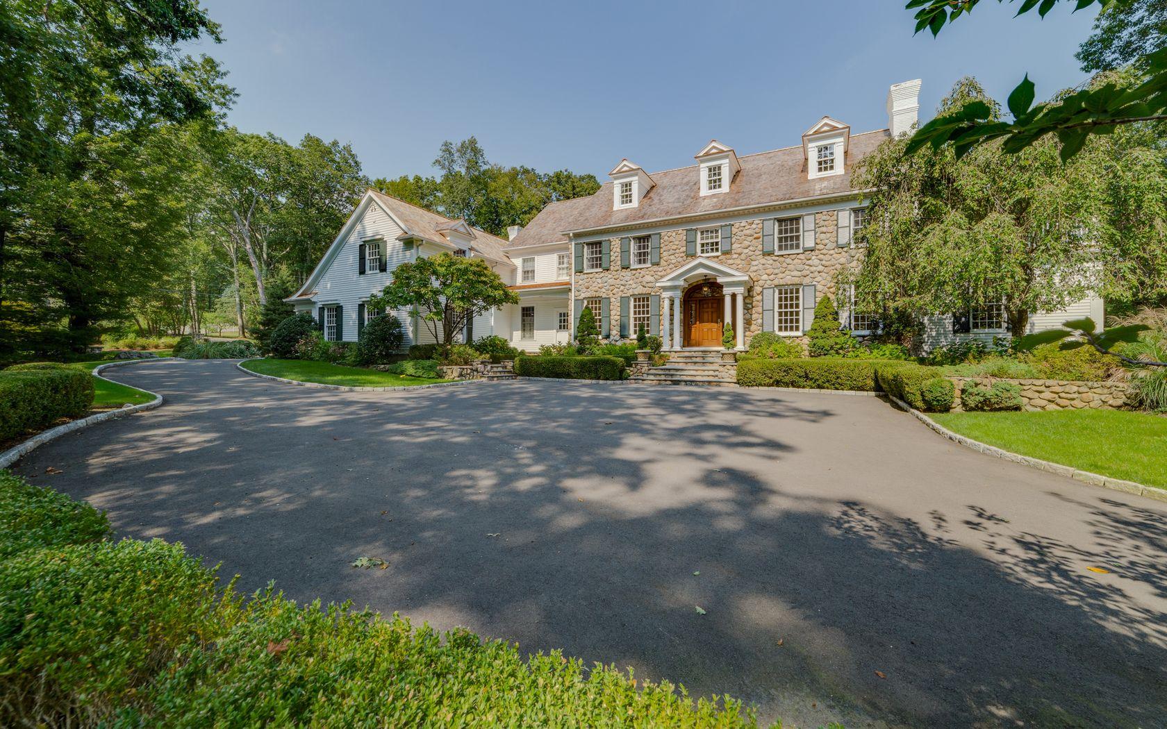 1601 Ponus Ridge Road New Canaan, CT 06840 - Photo 79 of 88 a front view of a house with a yard and outdoor seating