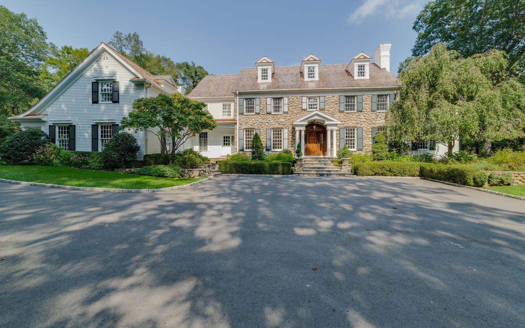 1601 Ponus Ridge Road New Canaan, CT 06840 - Photo 81 of 88 a front view of a house with a yard and garage