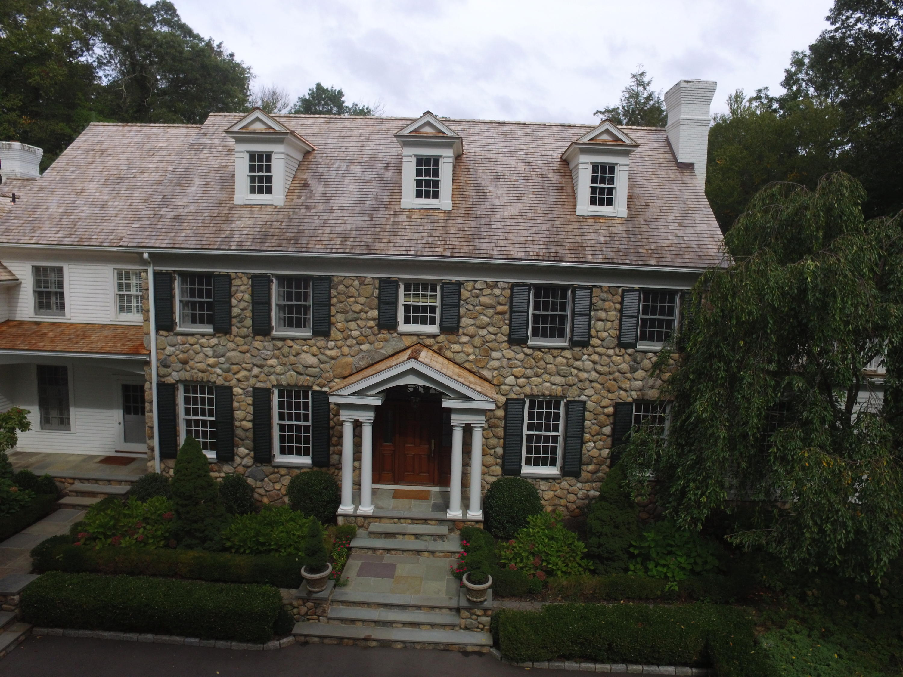 1601 Ponus Ridge Road New Canaan, CT 06840 - Photo 83 of 88 a front view of a house with a yard