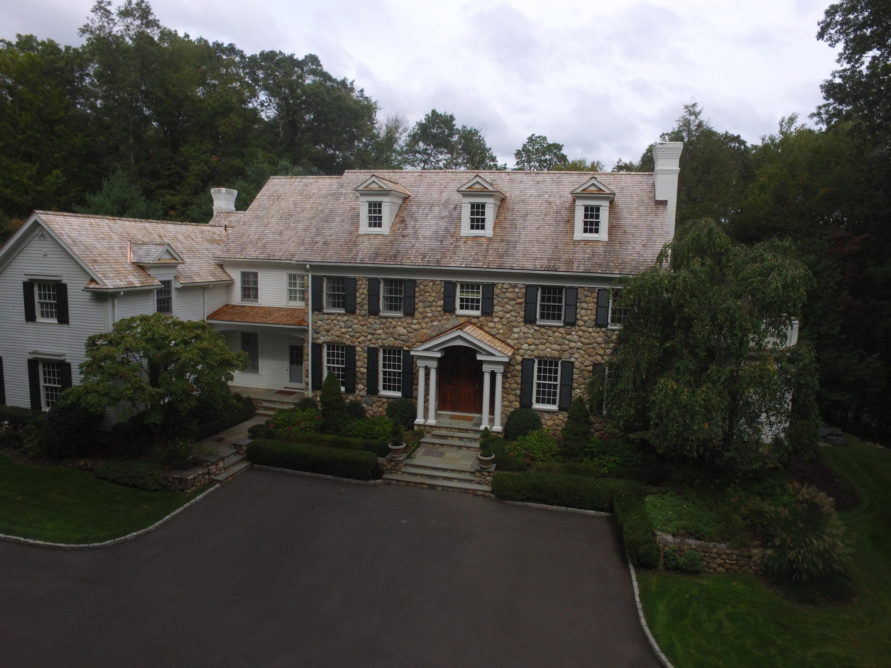 1601 Ponus Ridge Road New Canaan, CT 06840 - Photo 85 of 88 a front view of a house with garden