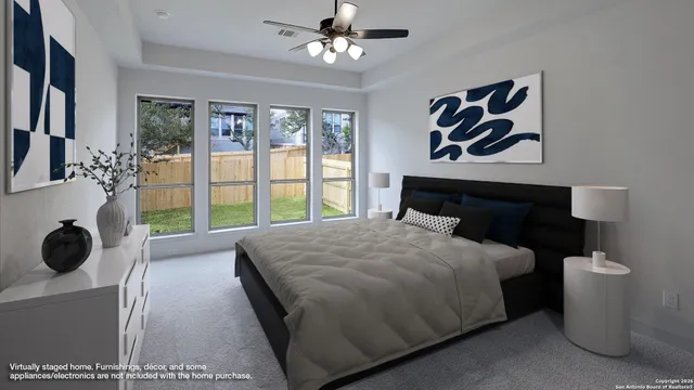 a bedroom with a bed and a large window