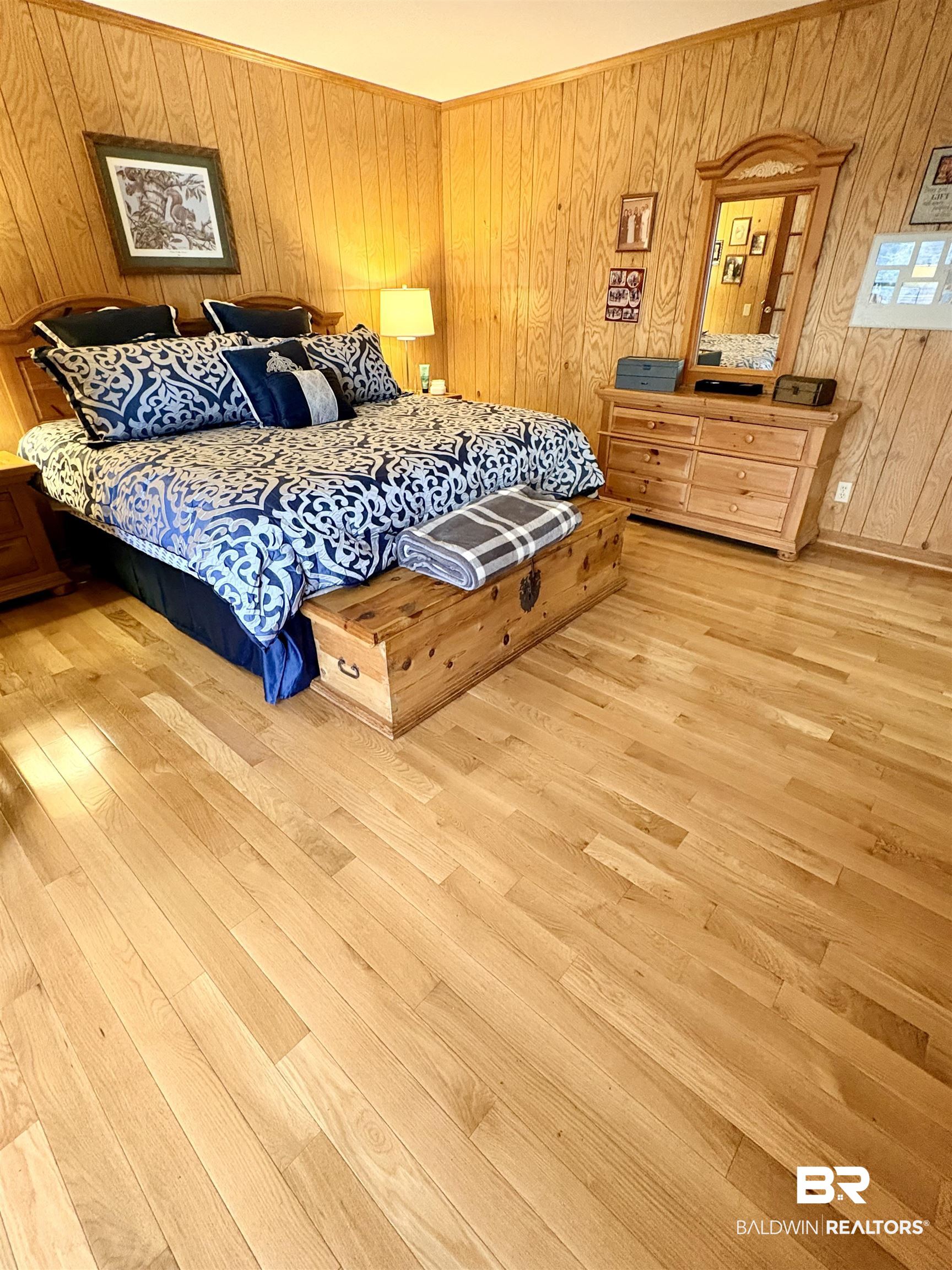 44 Ridge Road Castleberry, AL 36432 - Photo 5 of 33 Bedroom featuring wooden walls and light wood-style flooring
