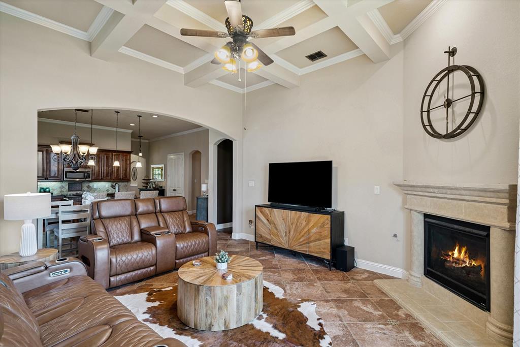 1007 Somerset Circle Forney, TX 75126 - Photo 11 of 34 a living room with furniture a flat screen tv and a fireplace