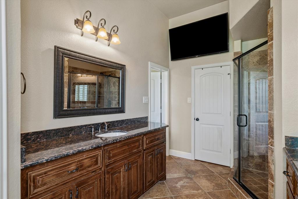 1007 Somerset Circle Forney, TX 75126 - Photo 17 of 34 a bathroom with a double vanity sink and mirror