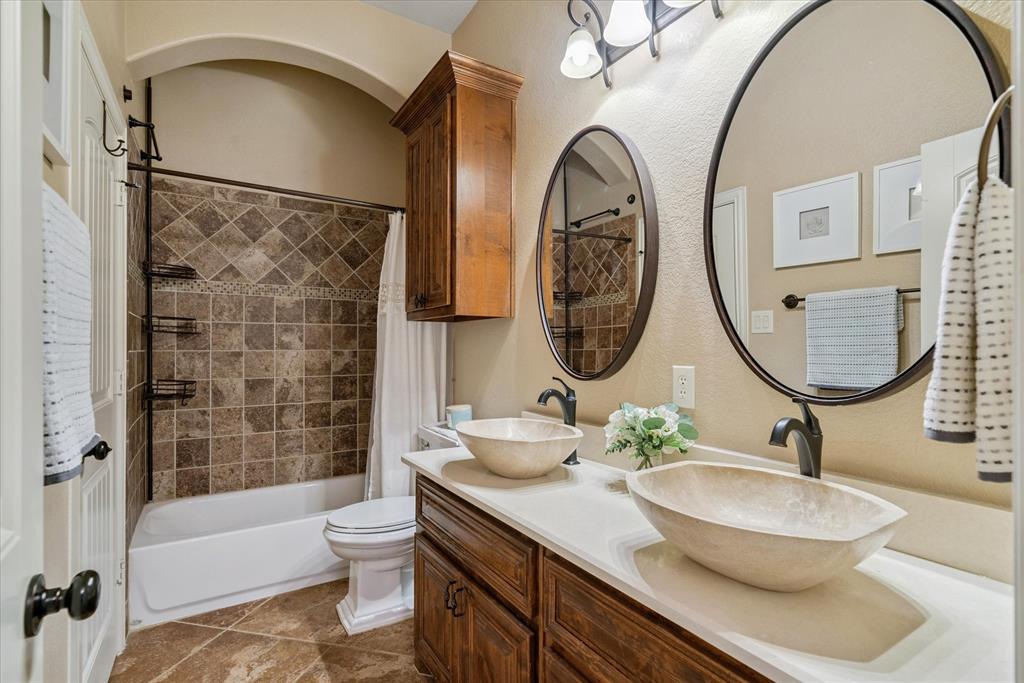 1007 Somerset Circle Forney, TX 75126 - Photo 24 of 34 a bathroom with a sink a toilet and a mirror