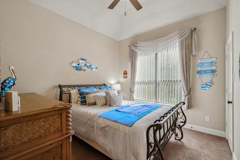 1007 Somerset Circle Forney, TX 75126 - Photo 27 of 34 a bedroom with a bed and a table in it