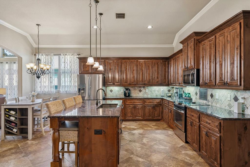 1007 Somerset Circle Forney, TX 75126 - Photo 30 of 34 a kitchen with sink cabinets and window