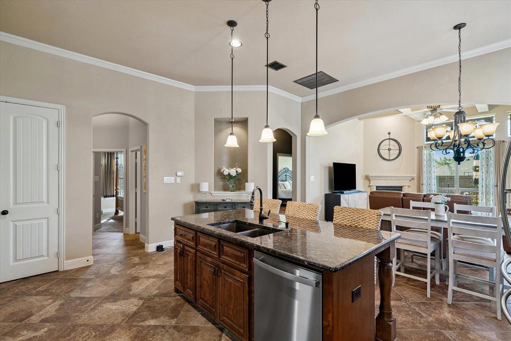 1007 Somerset Circle Forney, TX 75126 - Photo 31 of 34 a open kitchen with a sink a island with stainless steel appliances and cabinets