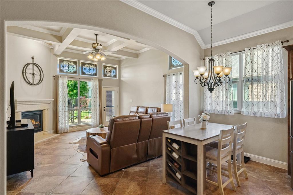 1007 Somerset Circle Forney, TX 75126 - Photo 34 of 34 a living room with furniture a fireplace and a chandelier