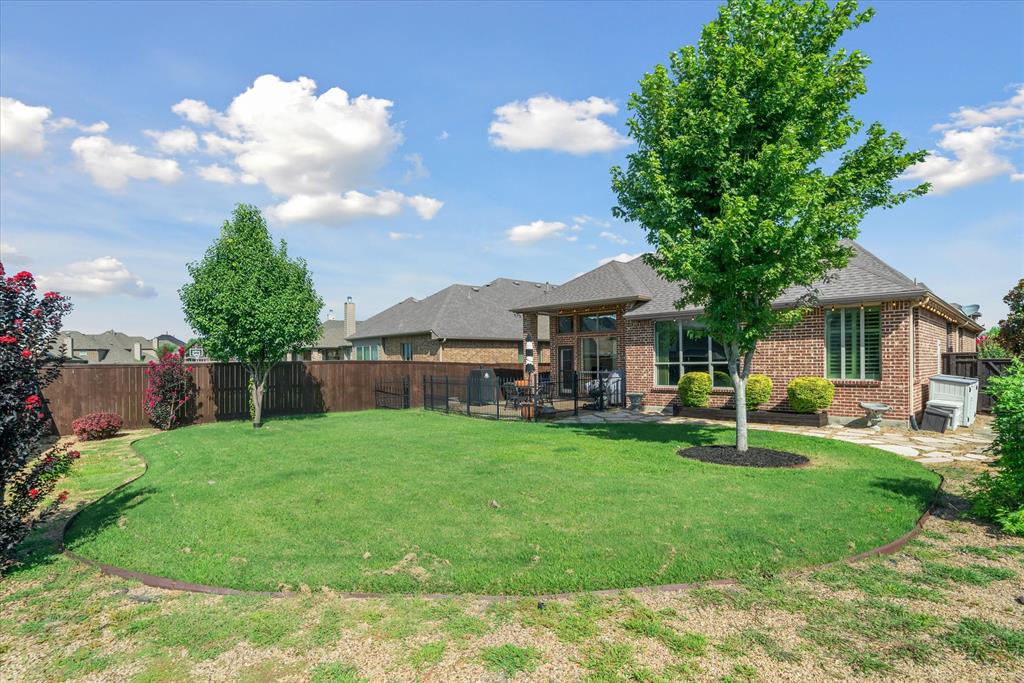 1007 Somerset Circle Forney, TX 75126 - Photo 8 of 34 a view of a house with backyard sitting area and garden