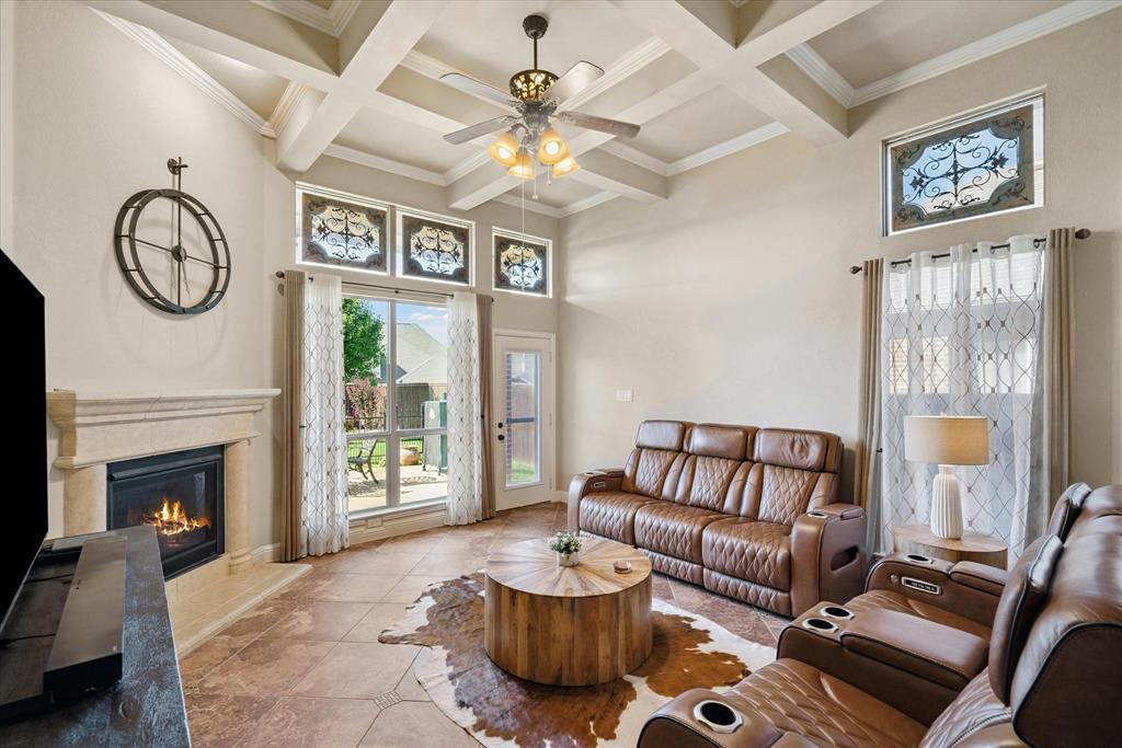 1007 Somerset Circle Forney, TX 75126 - Photo 9 of 34 a living room with furniture a fireplace and a chandelier