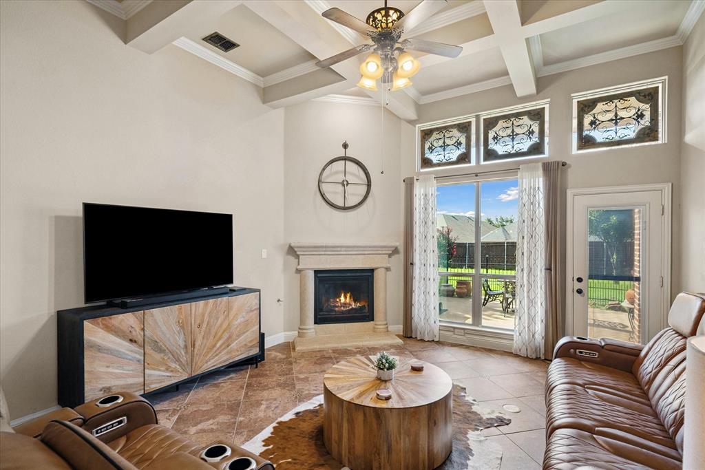 1007 Somerset Circle Forney, TX 75126 - Photo 10 of 34 a living room with furniture a fireplace and a flat screen tv