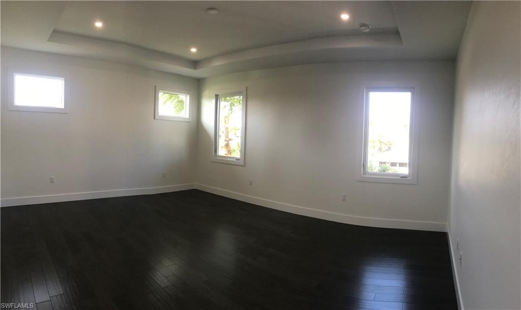 799 104th Avenue North Naples, FL 34108 - Photo 12 of 22 a view of an empty room with wooden floor and a window