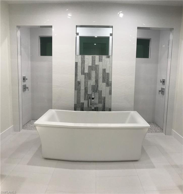 799 104th Avenue North Naples, FL 34108 - Photo 15 of 22 a white bath tub sitting in a bathroom
