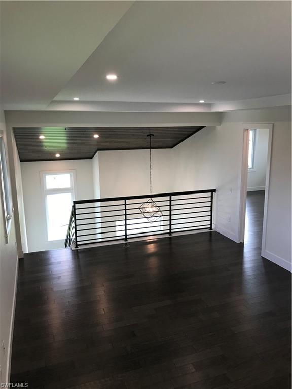 799 104th Avenue North Naples, FL 34108 - Photo 4 of 22 a view of empty room with wooden floor and fan
