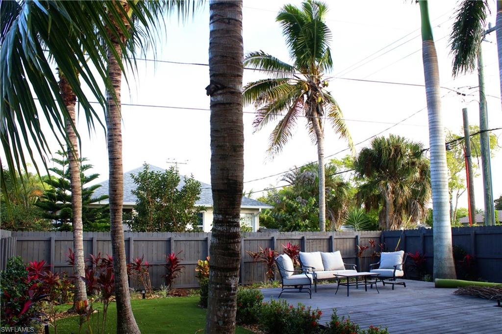 799 104th Avenue North Naples, FL 34108 - Photo 6 of 22 a backyard of a house with a garden and outdoor seating